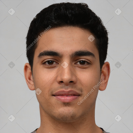 Joyful latino young-adult male with short  black hair and brown eyes