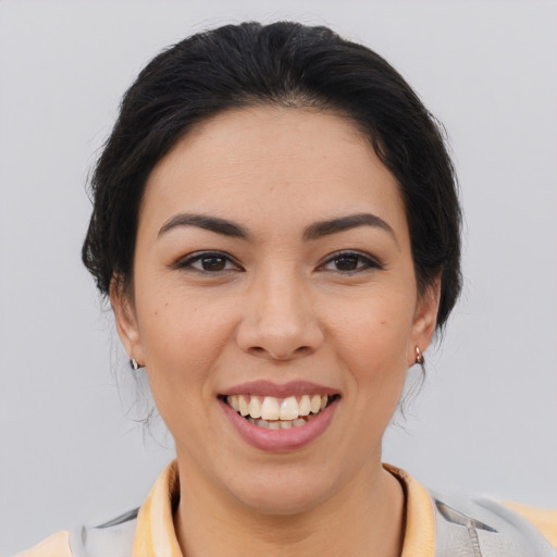 Joyful latino young-adult female with medium  brown hair and brown eyes