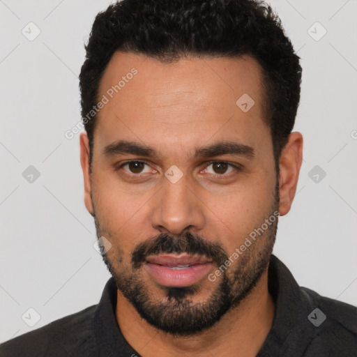 Neutral latino young-adult male with short  black hair and brown eyes