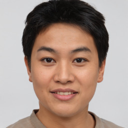 Joyful asian young-adult male with short  brown hair and brown eyes