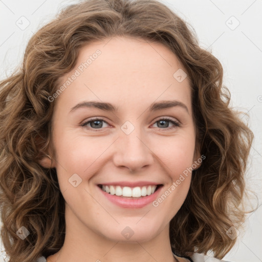 Joyful white young-adult female with long  brown hair and green eyes