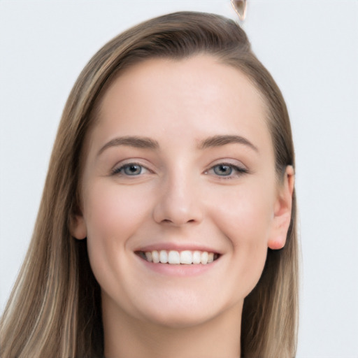 Joyful white young-adult female with long  brown hair and grey eyes