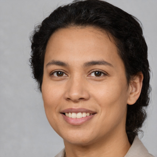 Joyful latino young-adult female with short  brown hair and brown eyes