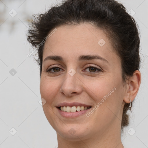 Joyful white adult female with medium  brown hair and grey eyes