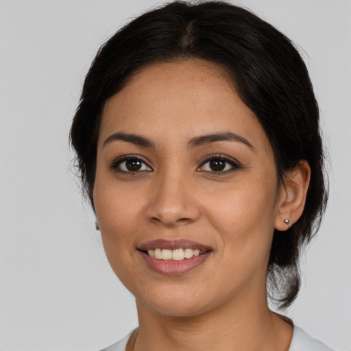 Joyful latino young-adult female with medium  brown hair and brown eyes