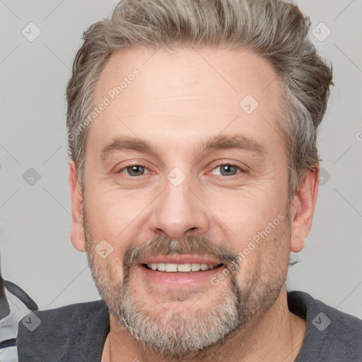 Joyful white adult male with short  brown hair and grey eyes