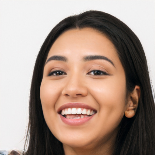 Joyful latino young-adult female with long  black hair and brown eyes