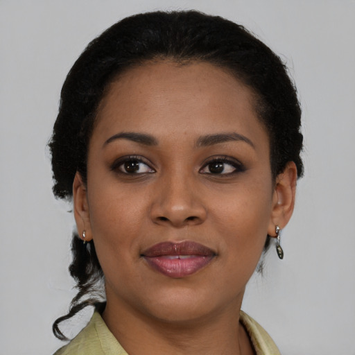 Joyful black young-adult female with short  brown hair and brown eyes