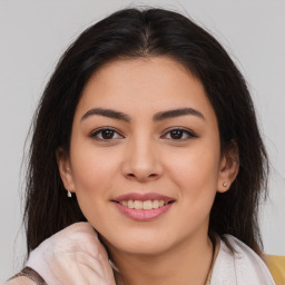 Joyful latino young-adult female with medium  brown hair and brown eyes