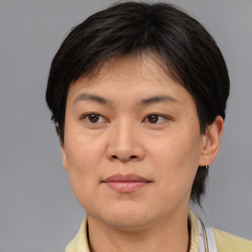 Joyful asian adult female with medium  brown hair and brown eyes