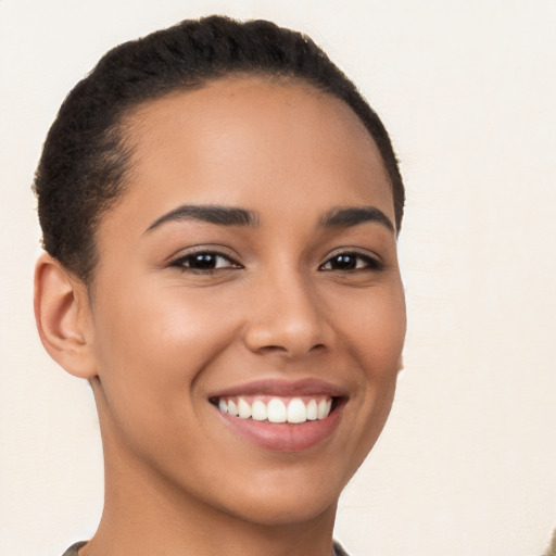 Joyful latino young-adult female with short  brown hair and brown eyes