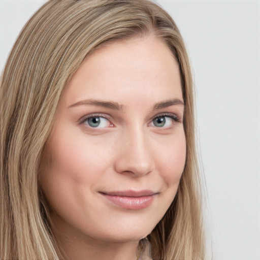 Joyful white young-adult female with long  brown hair and blue eyes