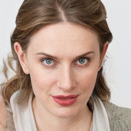 Joyful white young-adult female with medium  brown hair and blue eyes