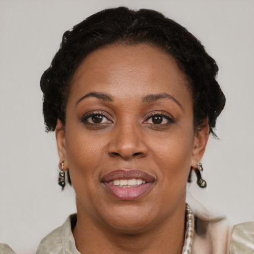 Joyful black adult female with short  brown hair and brown eyes