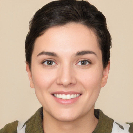 Joyful white young-adult female with short  brown hair and brown eyes