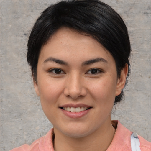 Joyful asian young-adult female with short  brown hair and brown eyes