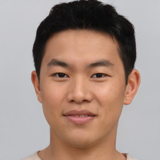 Joyful asian young-adult male with short  brown hair and brown eyes