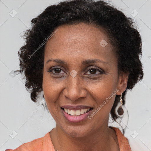 Joyful latino adult female with medium  brown hair and brown eyes