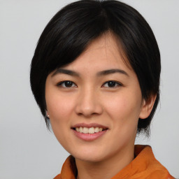 Joyful asian young-adult female with medium  black hair and brown eyes