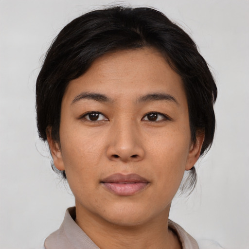 Joyful asian young-adult female with short  black hair and brown eyes