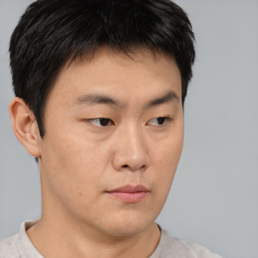 Neutral asian young-adult male with short  brown hair and brown eyes