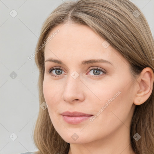 Joyful white young-adult female with long  brown hair and blue eyes