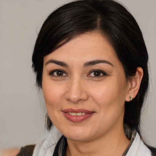 Joyful white adult female with medium  brown hair and brown eyes