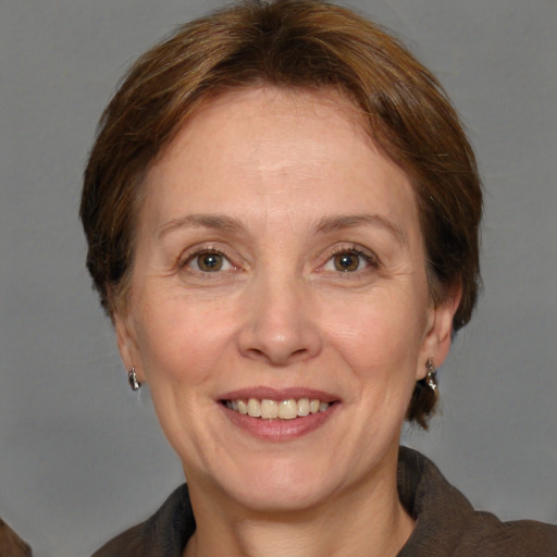 Joyful white adult female with medium  brown hair and grey eyes