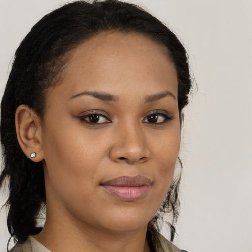 Joyful black young-adult female with long  brown hair and brown eyes