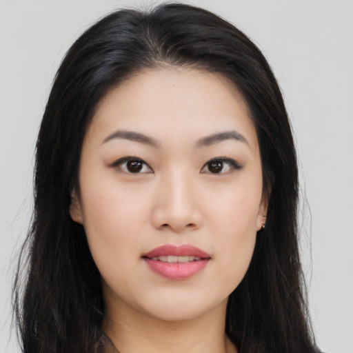 Joyful asian young-adult female with long  black hair and brown eyes