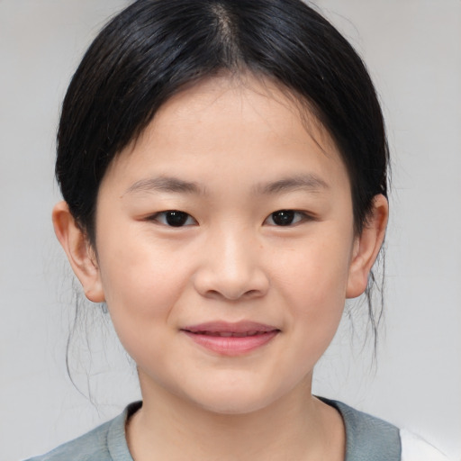 Joyful asian child female with medium  brown hair and brown eyes