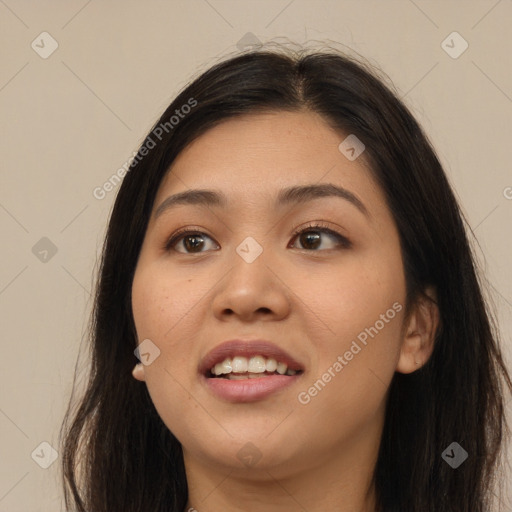 Joyful asian young-adult female with long  brown hair and brown eyes