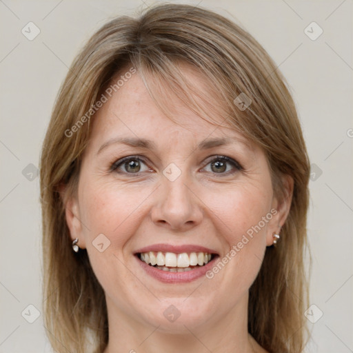 Joyful white adult female with medium  brown hair and green eyes