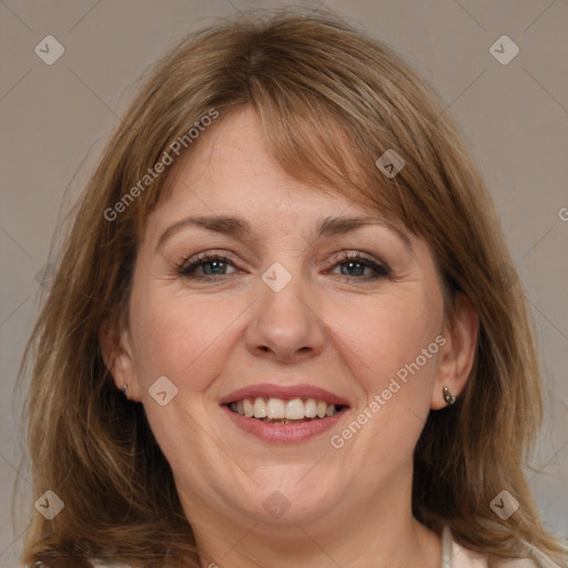 Joyful white adult female with medium  brown hair and grey eyes