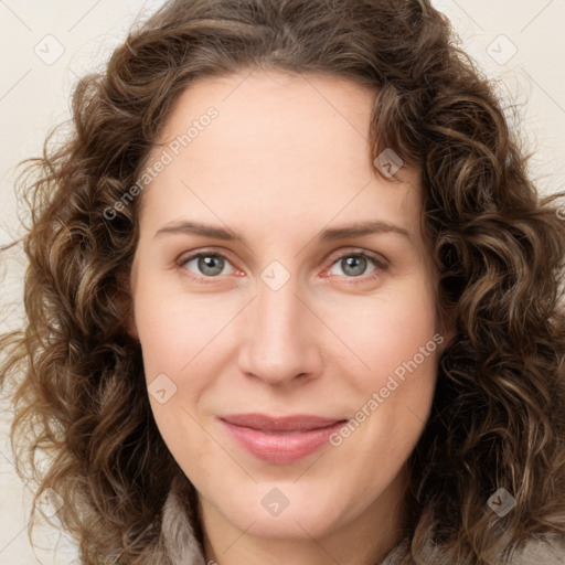 Joyful white young-adult female with long  brown hair and green eyes