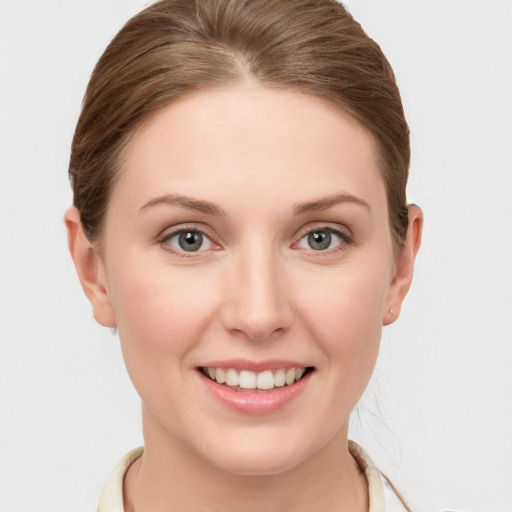 Joyful white young-adult female with short  brown hair and grey eyes