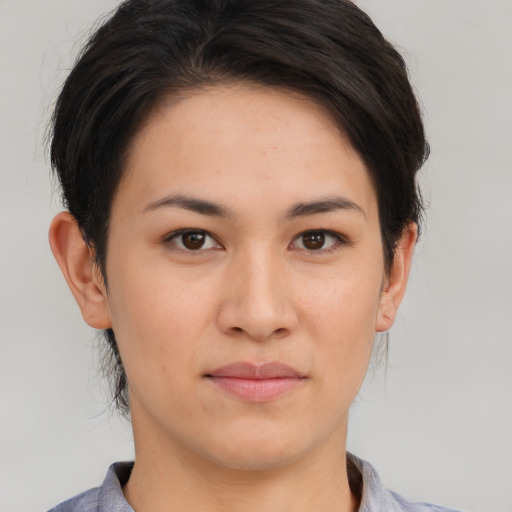 Joyful asian young-adult female with short  brown hair and brown eyes