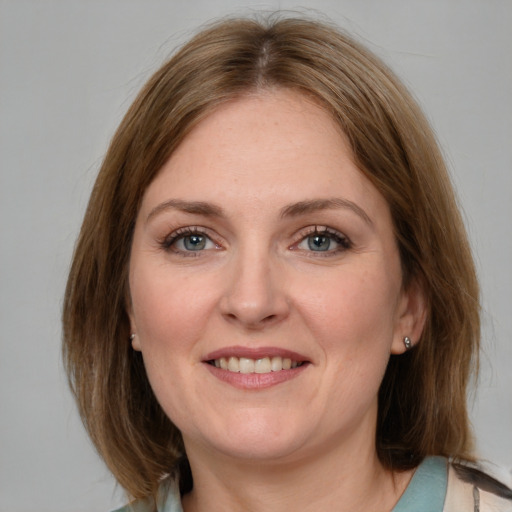 Joyful white adult female with medium  brown hair and grey eyes