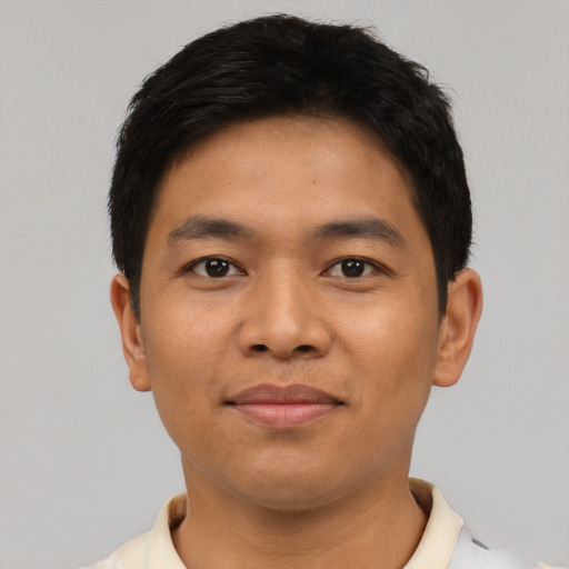 Joyful asian young-adult male with short  black hair and brown eyes