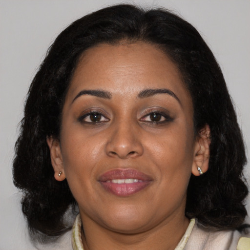 Joyful black young-adult female with medium  brown hair and brown eyes