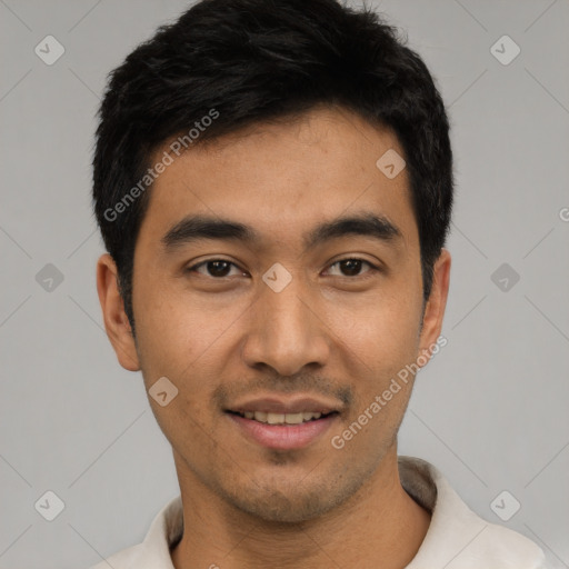 Joyful latino young-adult male with short  black hair and brown eyes