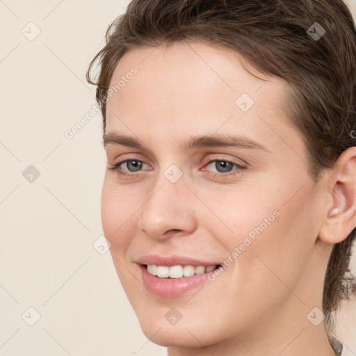 Joyful white young-adult female with medium  brown hair and grey eyes