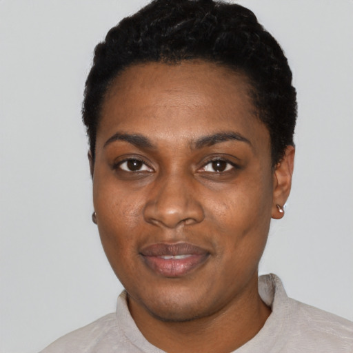 Joyful black young-adult female with short  black hair and brown eyes