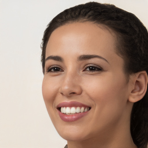 Joyful white young-adult female with long  brown hair and brown eyes