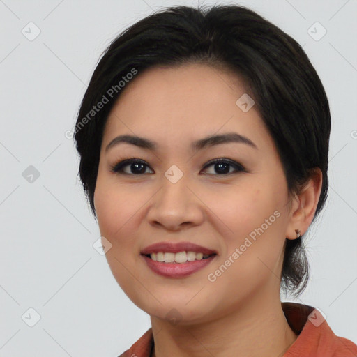 Joyful asian young-adult female with medium  black hair and brown eyes