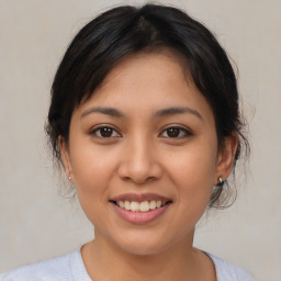 Joyful asian young-adult female with medium  brown hair and brown eyes