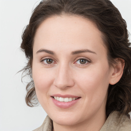 Joyful white young-adult female with medium  brown hair and grey eyes