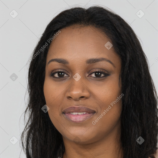 Joyful black young-adult female with long  black hair and brown eyes