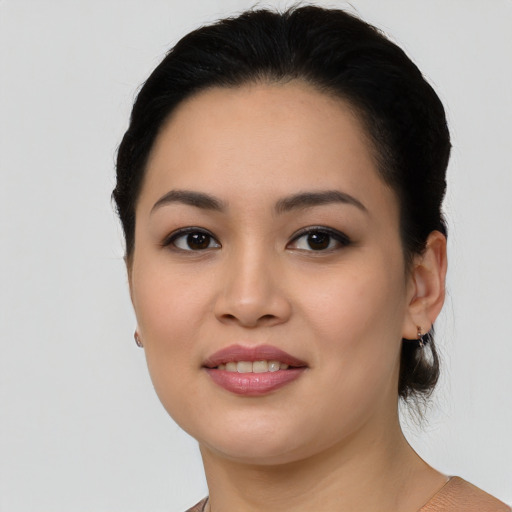 Joyful asian young-adult female with medium  black hair and brown eyes