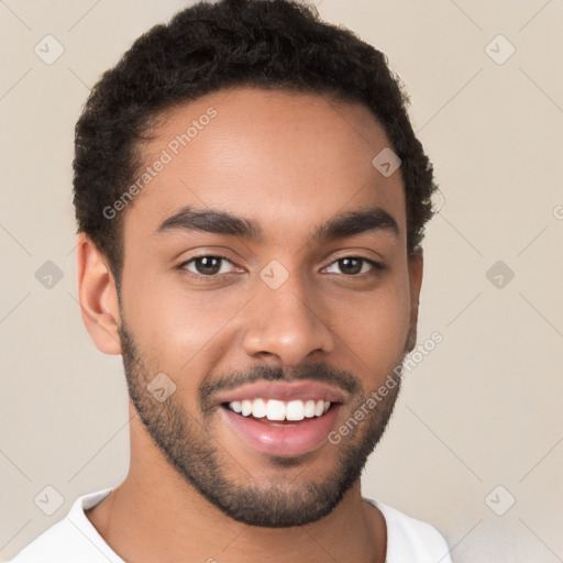 Joyful latino young-adult male with short  brown hair and brown eyes